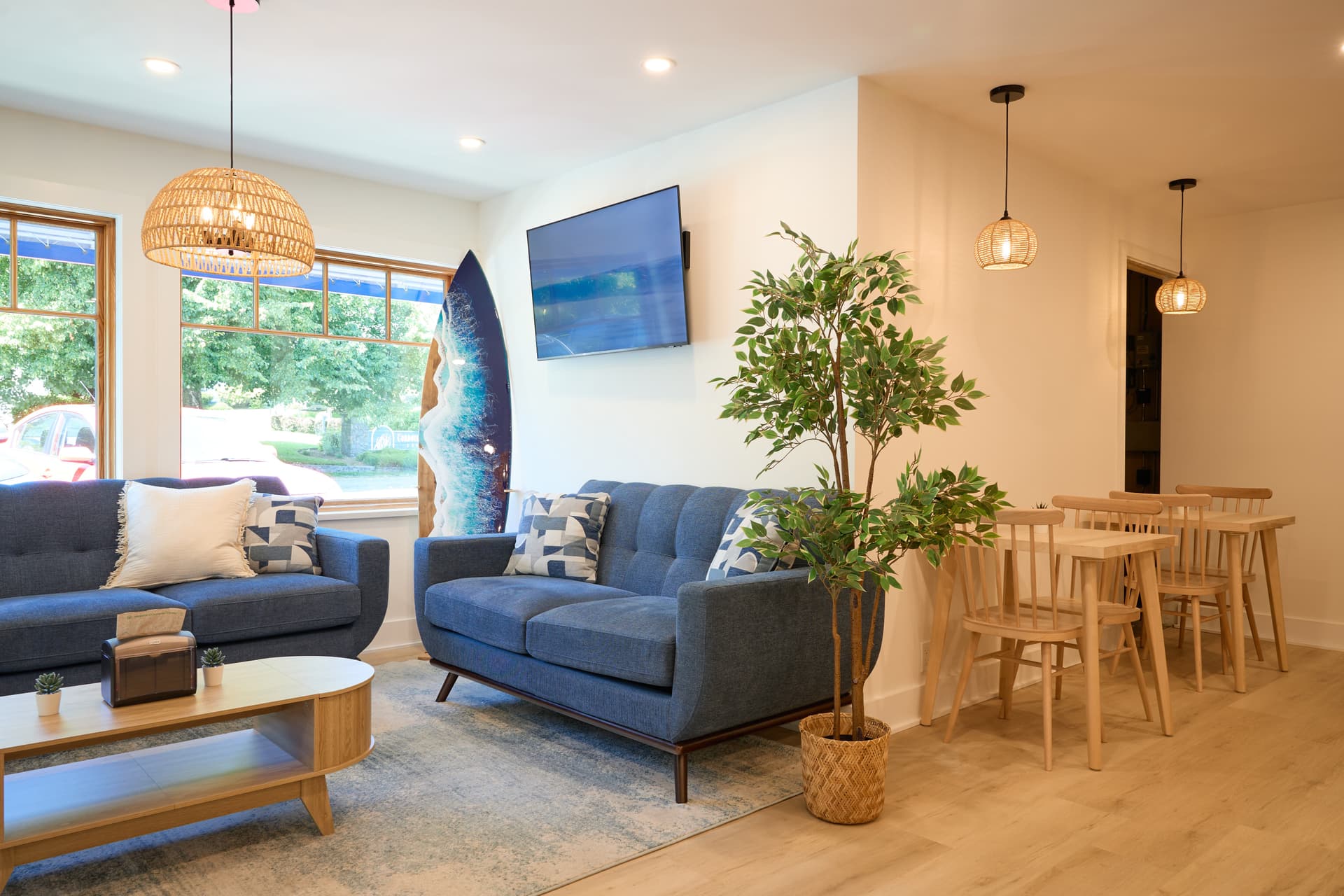 Bright lounge and dining area with coastal décor and natural light