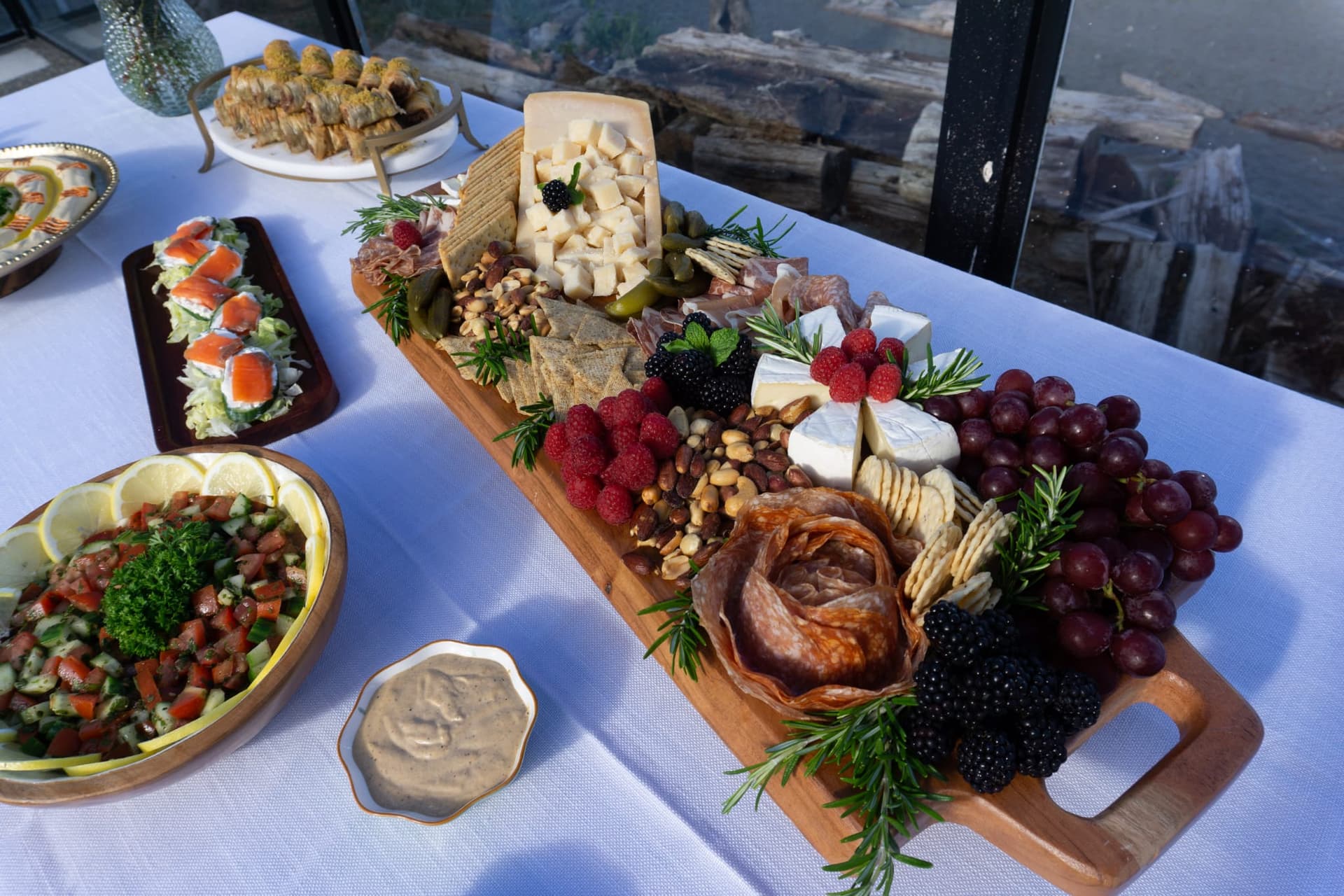 Abundant charcuterie and appetizer spread on the patio