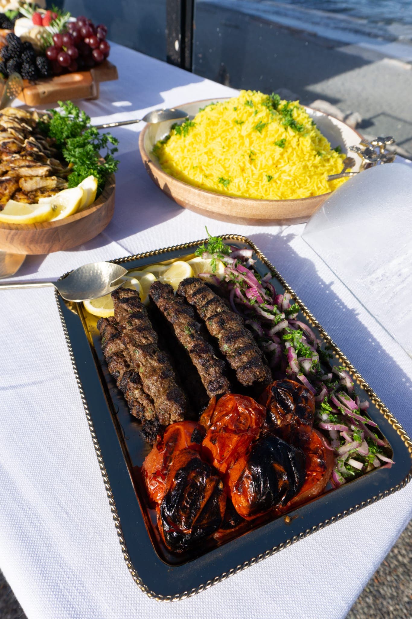 Grilled kebabs and vegetables served for patio dining