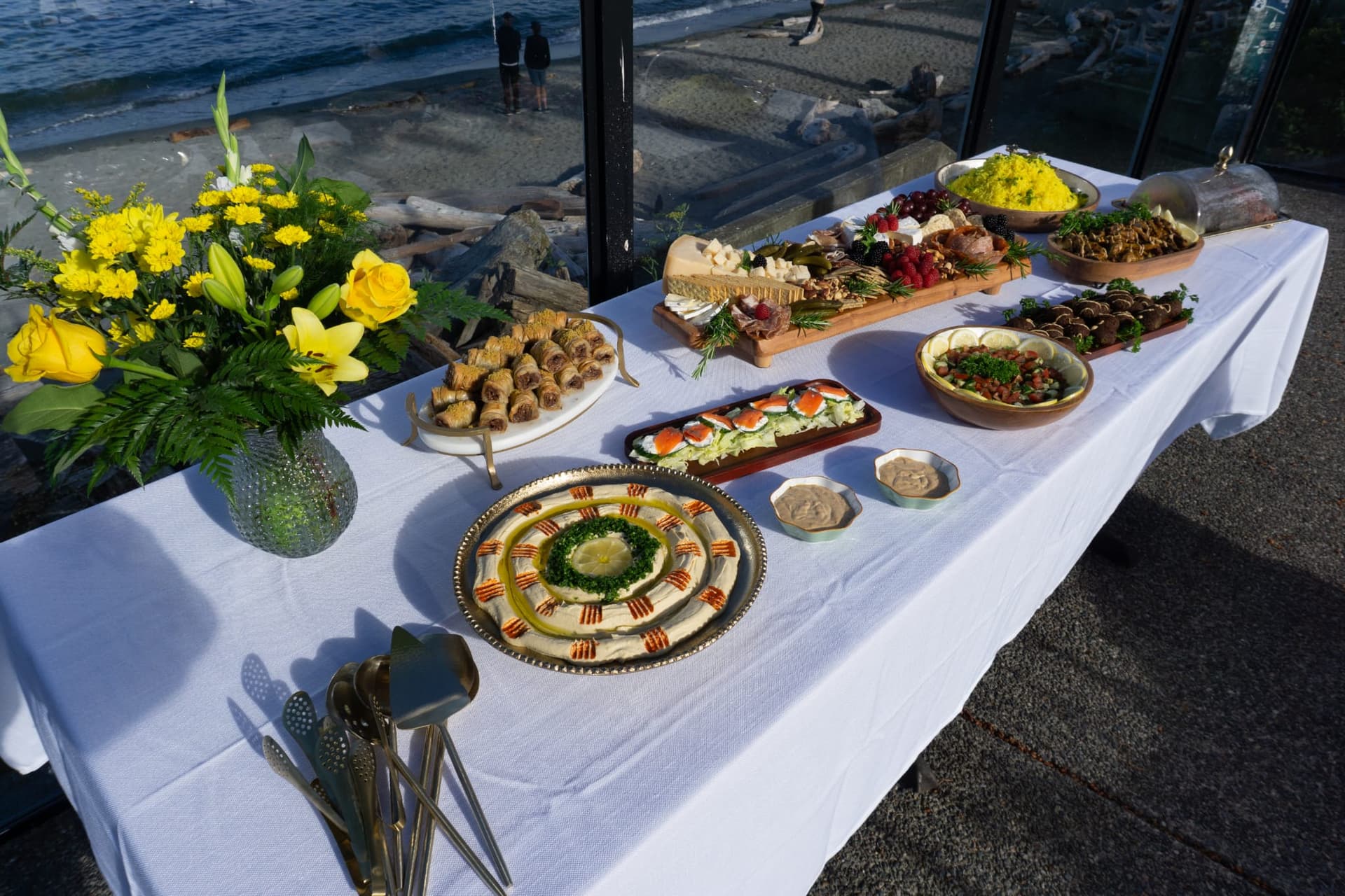 Catered buffet spread beside the beach